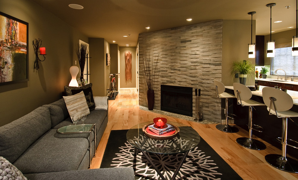 This is an example of a contemporary living room in Seattle with a corner fireplace.