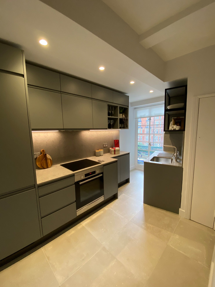 Inspiration for a small modern galley separate kitchen in London with flat-panel cabinets, grey cabinets, quartzite benchtops, grey splashback, porcelain floors, grey floor, grey benchtop and recessed.