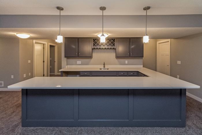 Inspiration for a mid-sized transitional u-shaped kitchen remodel with an undermount sink, shaker cabinets, gray cabinets and solid surface countertops