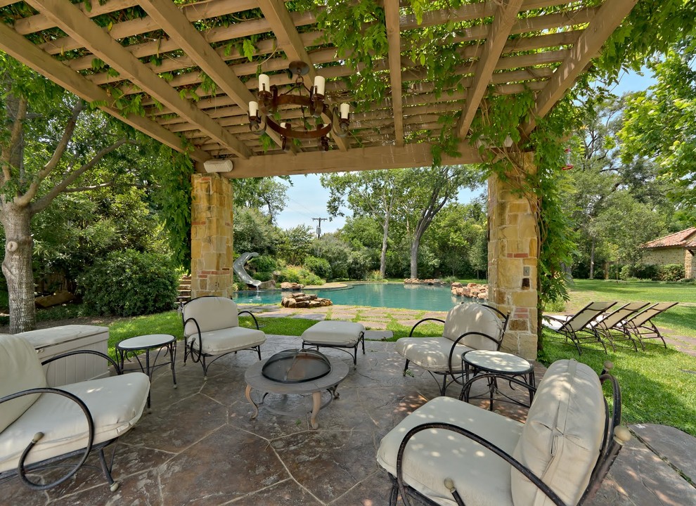 Inspiration for a mediterranean backyard patio in Dallas with a fire feature and a pergola.