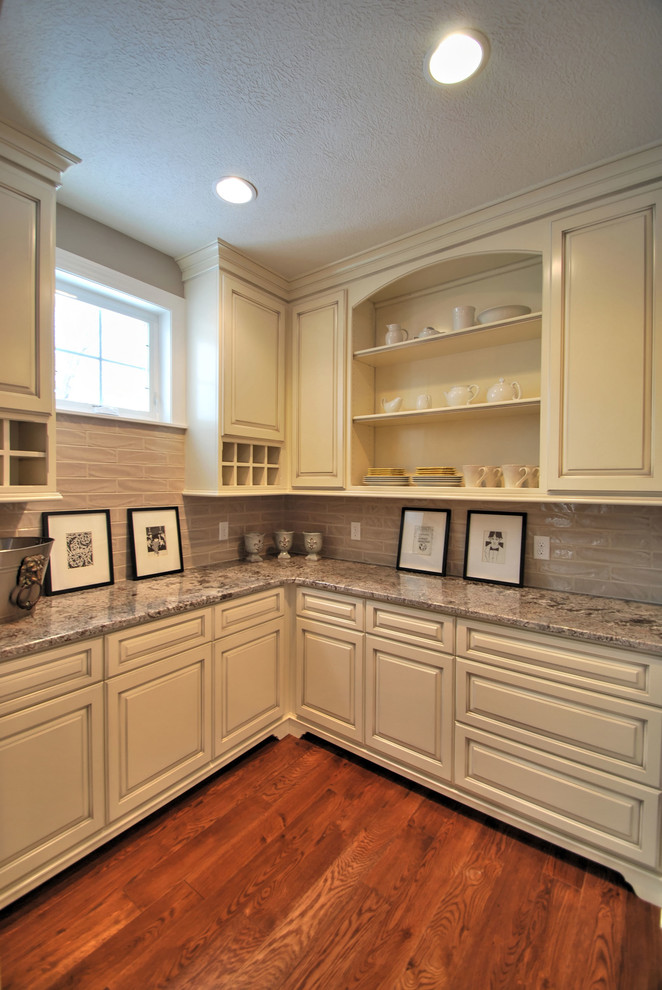 Inspiration for a large traditional l-shaped kitchen pantry in Cleveland with a farmhouse sink, glass-front cabinets, white cabinets, granite benchtops, ceramic splashback, stainless steel appliances, dark hardwood floors and with island.