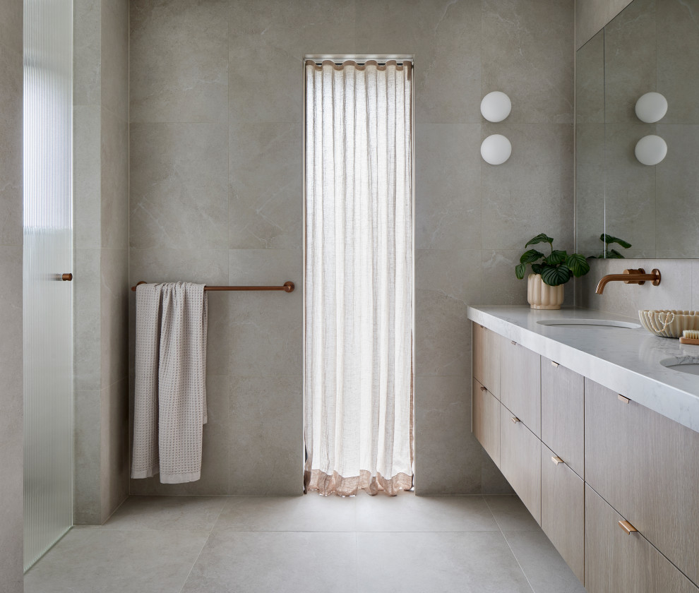 Photo of a mid-sized modern bathroom in Melbourne with beige tile, porcelain tile, beige walls, porcelain floors, an undermount sink, engineered quartz benchtops, beige floor, a hinged shower door, white benchtops, a double vanity, a floating vanity, flat-panel cabinets, light wood cabinets and an alcove shower.