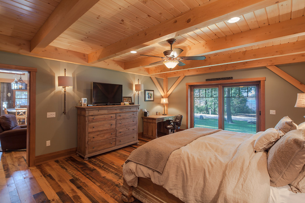 Photo of a country bedroom in Boston with grey walls and dark hardwood floors.