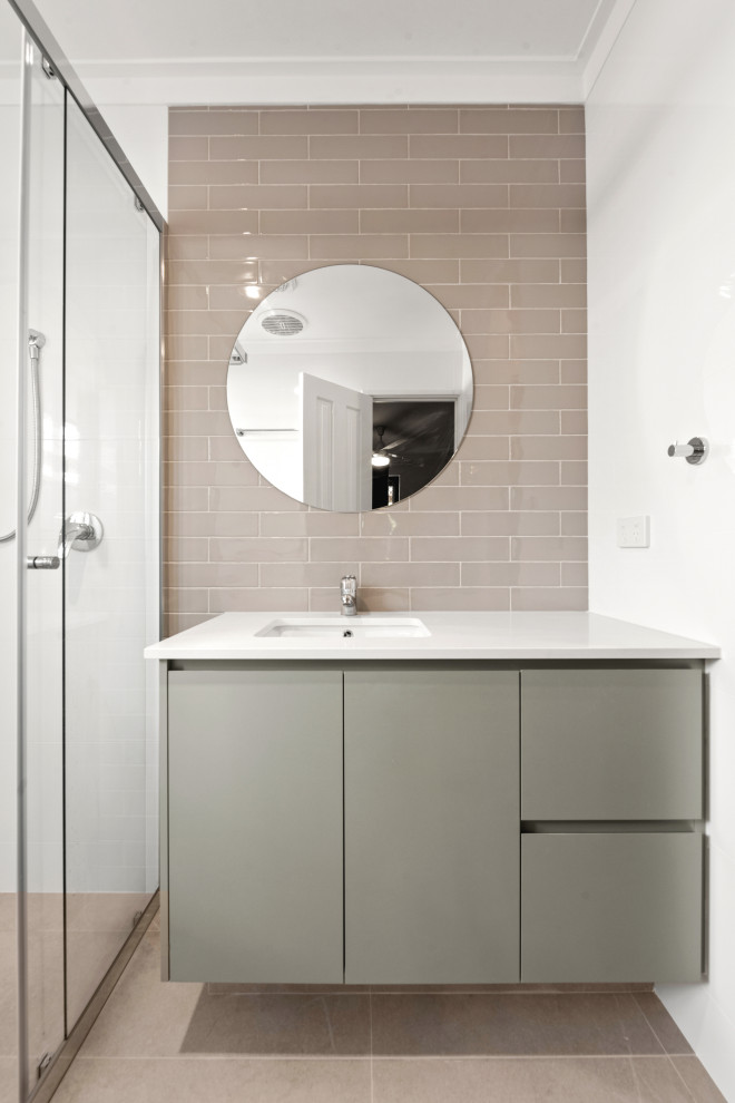 Photo of a small contemporary 3/4 bathroom in Perth with shaker cabinets, green cabinets, a corner shower, a one-piece toilet, beige tile, subway tile, white walls, an undermount sink, beige floor, a sliding shower screen, white benchtops, a single vanity and a built-in vanity.