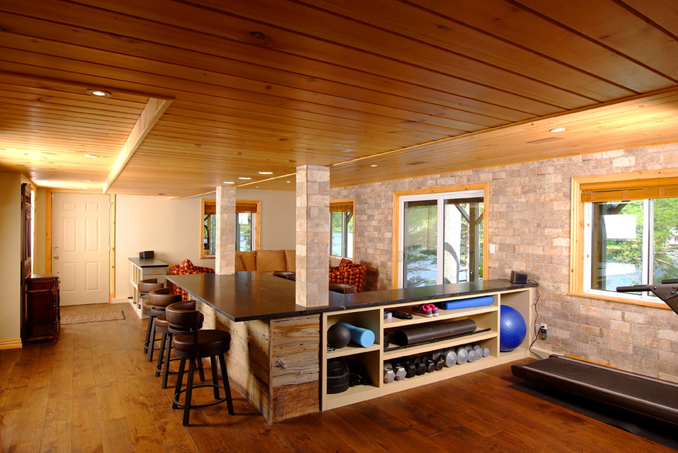 Example of a mid-sized mountain style walk-out dark wood floor basement design in Toronto with beige walls