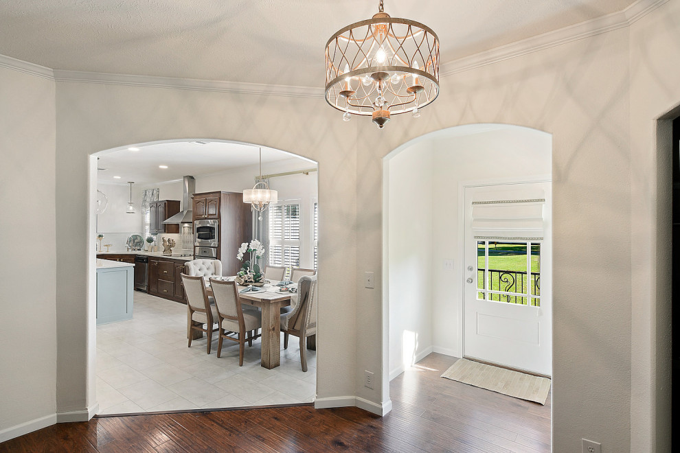 Foyer - mid-sized transitional dark wood floor and brown floor foyer idea with white walls and a white front door