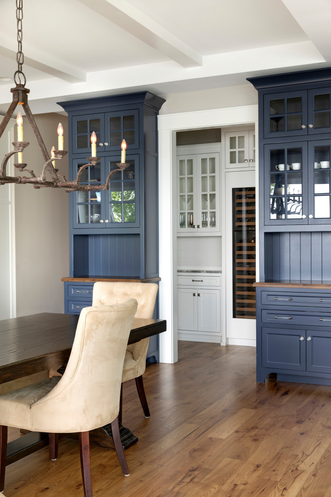 Inspiration for a beach style home bar in Minneapolis with blue cabinets, wood benchtops, blue splashback, shiplap splashback, medium hardwood floors and brown benchtop.