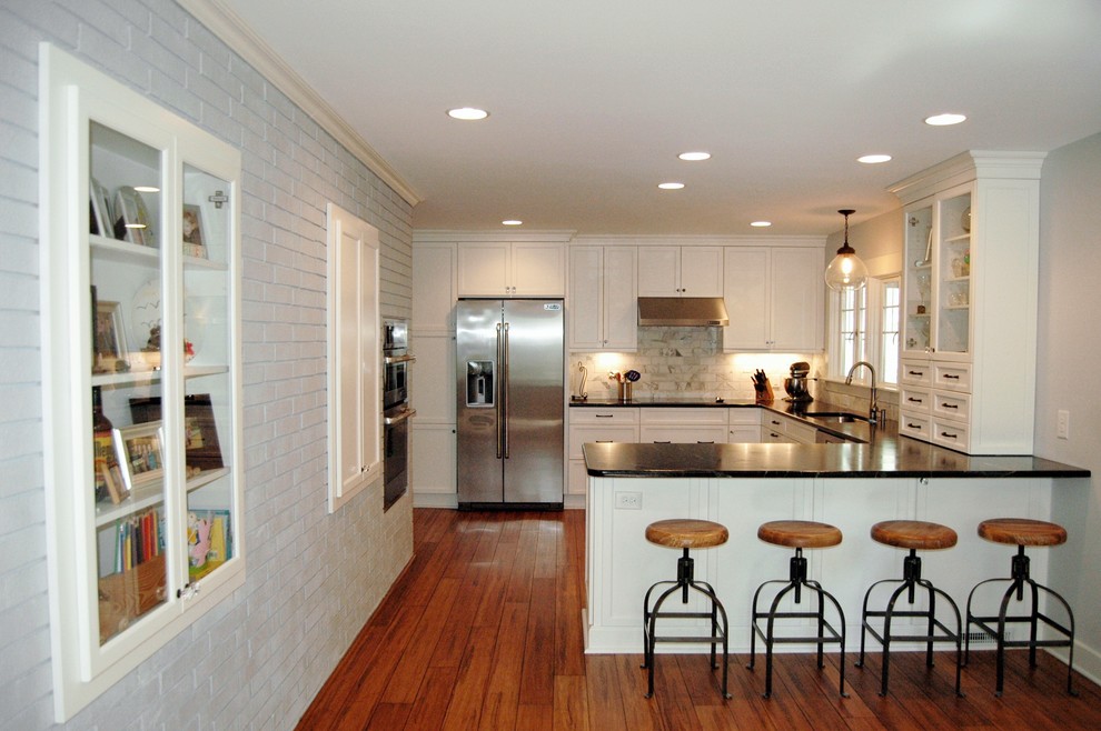 Transitional u-shaped kitchen photo in Raleigh with shaker cabinets, white cabinets and stainless steel appliances