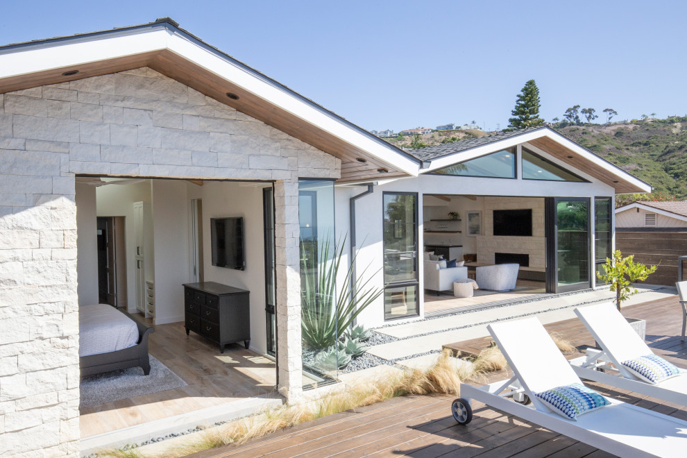 Inspiration for a transitional backyard deck remodel in Orange County with a fire pit