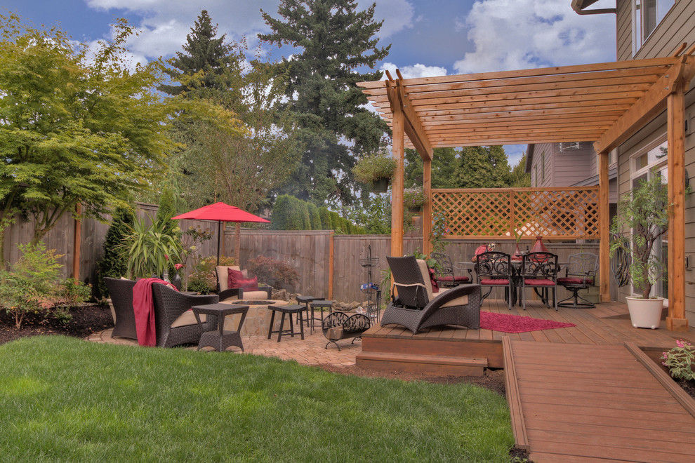 Design ideas for a traditional backyard deck in Portland with a pergola.