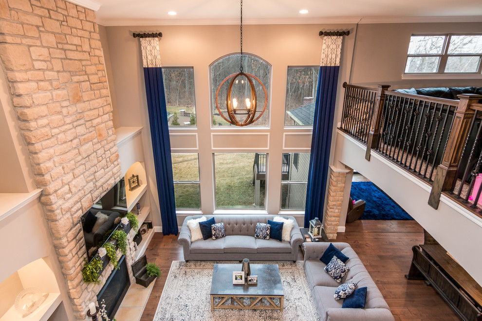 This is an example of a mid-sized transitional open concept family room in St Louis.
