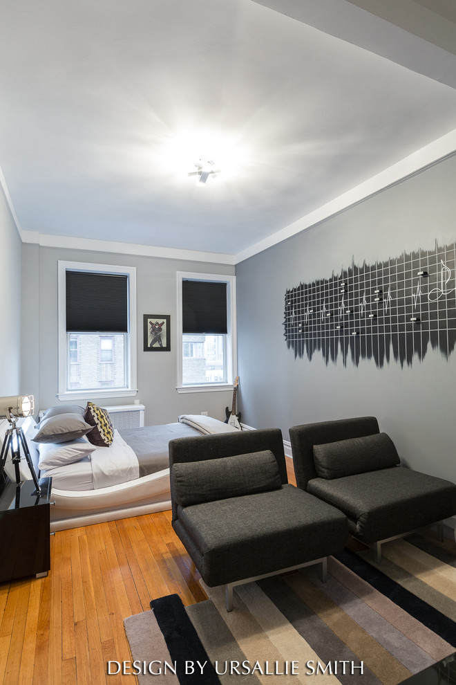 This is an example of a mid-sized gender-neutral kids' room in New York with grey walls.