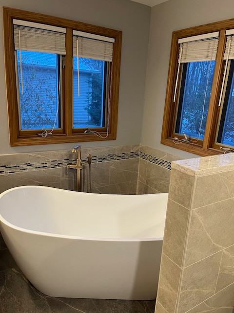 Example of a large transitional master gray tile and porcelain tile porcelain tile and gray floor freestanding bathtub design with gray walls