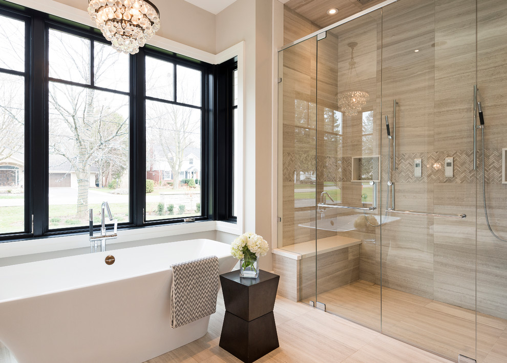 Design ideas for a large transitional master bathroom in Toronto with a freestanding tub, a double shower, porcelain floors, beige tile, beige walls and limestone.