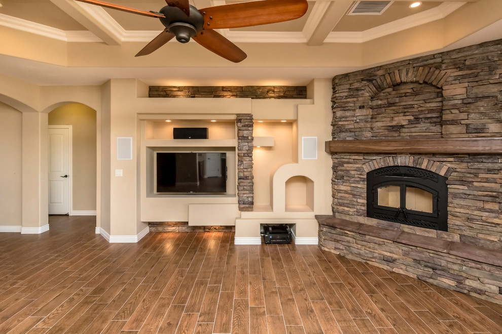 Photo of a mid-sized transitional open concept living room in Phoenix with beige walls, porcelain floors, a corner fireplace, a stone fireplace surround and a built-in media wall.