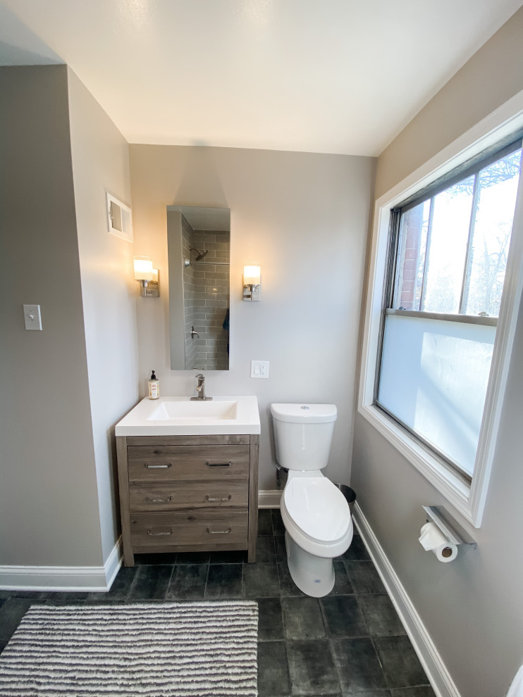 Inspiration for a small classic bathroom in Chicago with flat-panel cabinets, distressed cabinets, an alcove bath, a shower/bath combination, a two-piece toilet, grey walls, porcelain flooring, blue floors, white worktops, a single sink, a freestanding vanity unit, grey tiles, porcelain tiles, an integrated sink and a shower curtain.