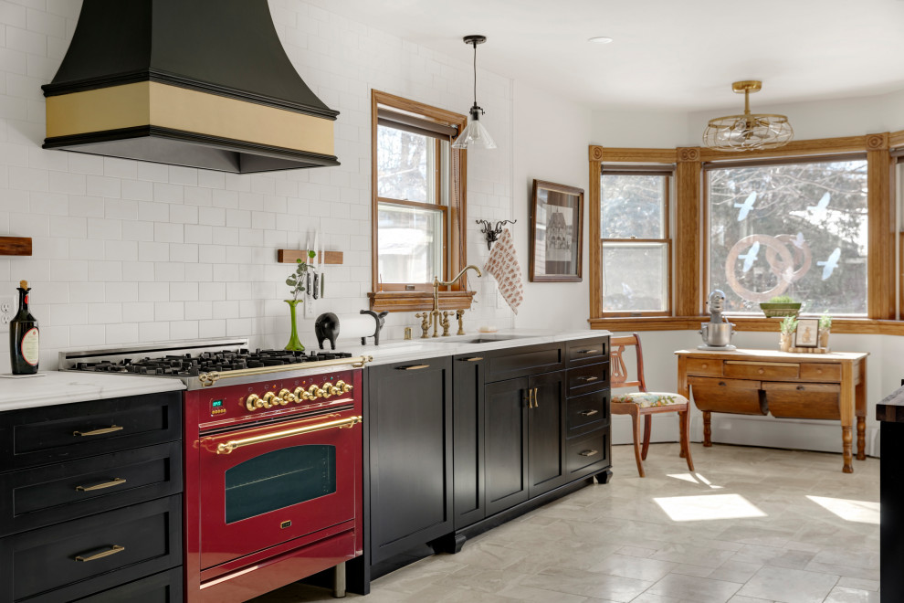 Large traditional galley eat-in kitchen in Minneapolis with an undermount sink, shaker cabinets, black cabinets, marble benchtops, white splashback, subway tile splashback, coloured appliances, marble floors, no island, beige floor and white benchtop.