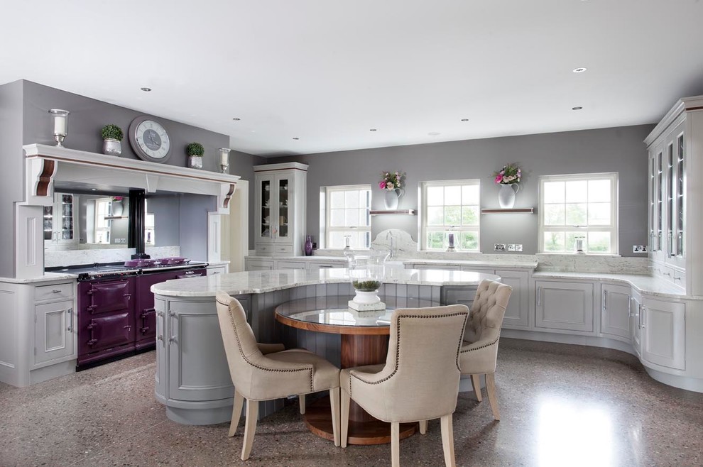 This is an example of a large traditional open plan kitchen in Belfast with a farmhouse sink, beaded inset cabinets, grey cabinets, granite benchtops, white splashback, stone slab splashback, with island and coloured appliances.