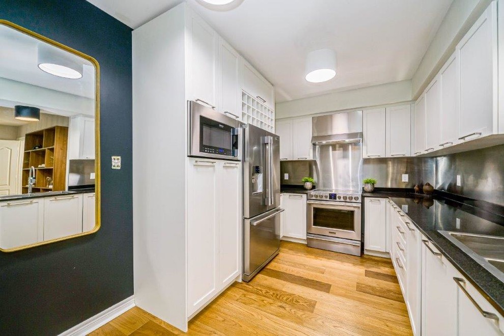 Example of a transitional kitchen design in Toronto