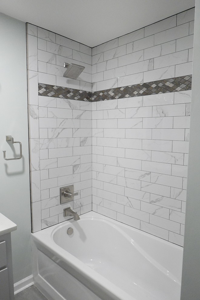 Inspiration for a mid-sized transitional kids' white tile and porcelain tile porcelain tile and gray floor alcove bathtub remodel with shaker cabinets, gray cabinets, a two-piece toilet, green walls, an undermount sink, quartz countertops and white countertops