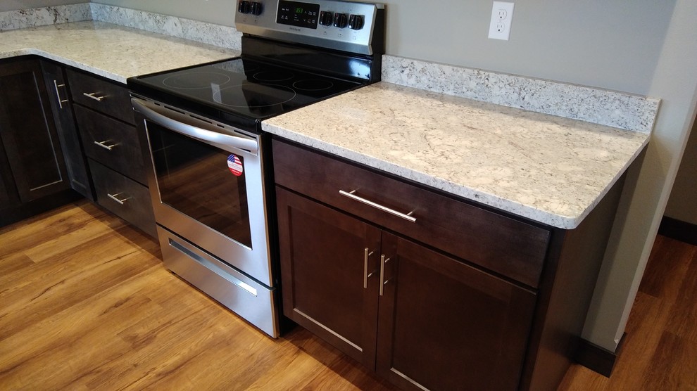 Inspiration for a mid-sized transitional l-shaped vinyl floor and brown floor eat-in kitchen remodel in Cedar Rapids with a double-bowl sink, shaker cabinets, gray cabinets, granite countertops, stainless steel appliances and an island