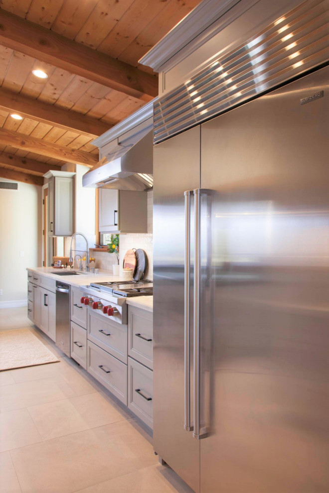 Inspiration for a large rustic galley porcelain tile, gray floor and wood ceiling open concept kitchen remodel in Denver with an undermount sink, recessed-panel cabinets, gray cabinets, quartzite countertops, white backsplash, cement tile backsplash, stainless steel appliances, an island and white countertops