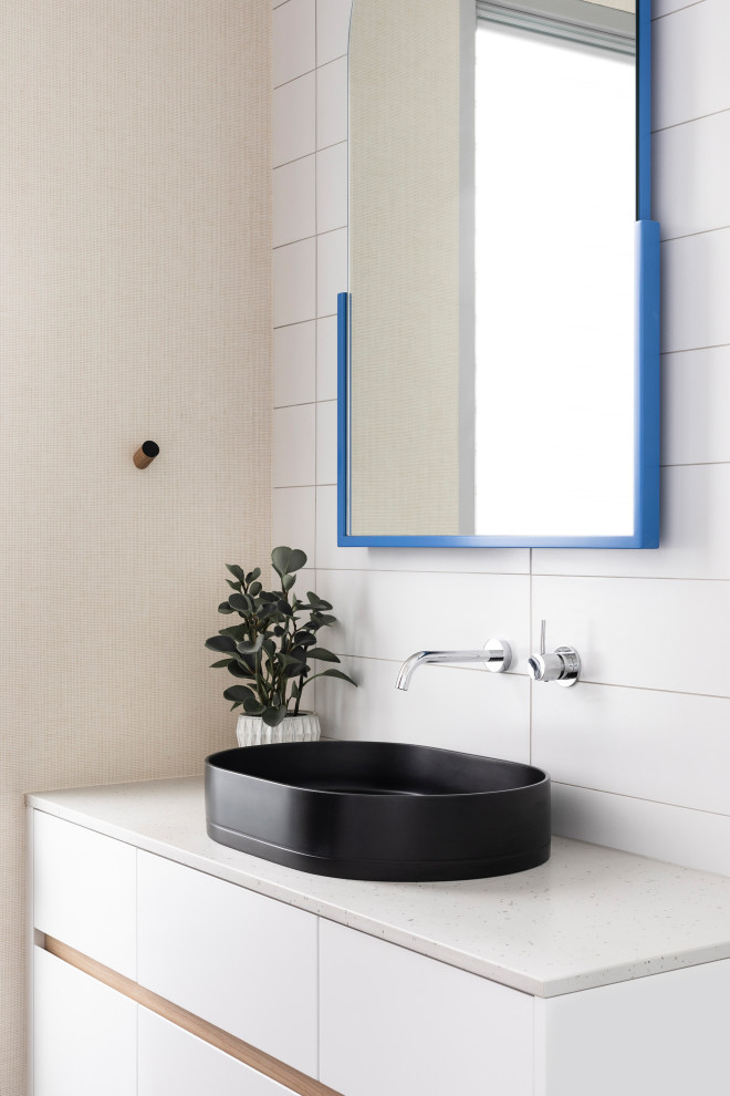 Inspiration for a mid-sized contemporary 3/4 bathroom in Melbourne with flat-panel cabinets, white cabinets, a double shower, a one-piece toilet, white tile, porcelain tile, white walls, concrete floors, a vessel sink, engineered quartz benchtops, black floor, a sliding shower screen, white benchtops, a single vanity, a built-in vanity and wallpaper.