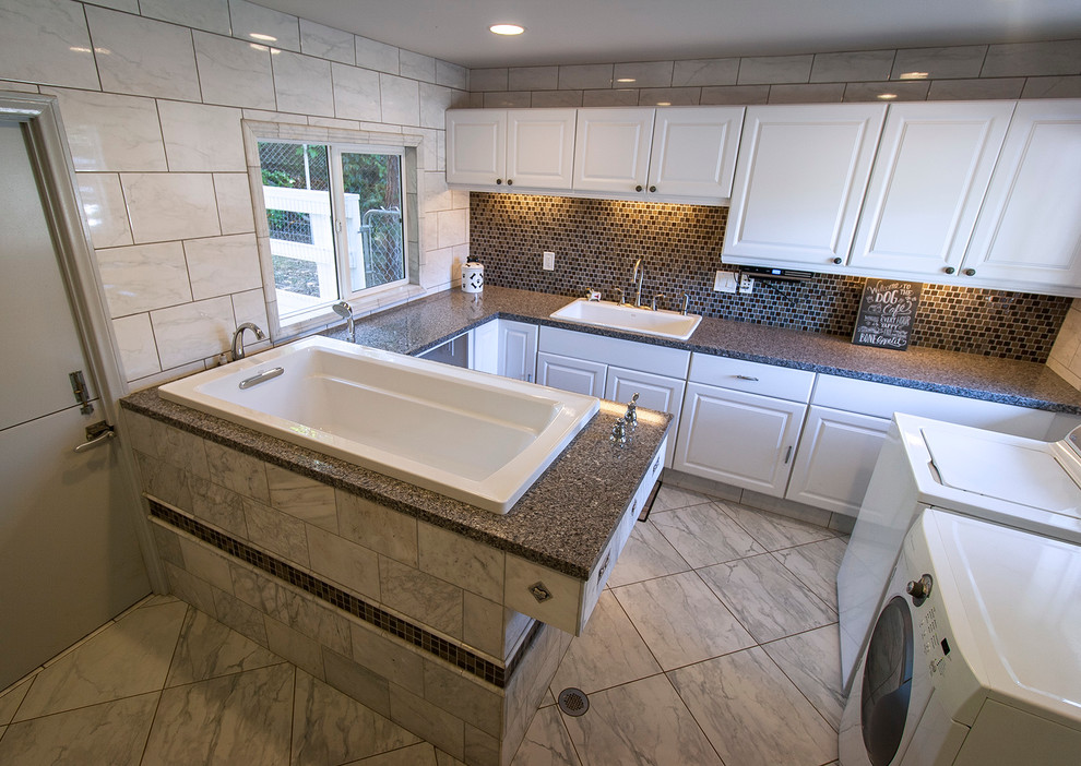 Large transitional u-shaped utility room in San Diego with a single-bowl sink, white cabinets, granite benchtops, white walls, marble floors, a side-by-side washer and dryer and raised-panel cabinets.