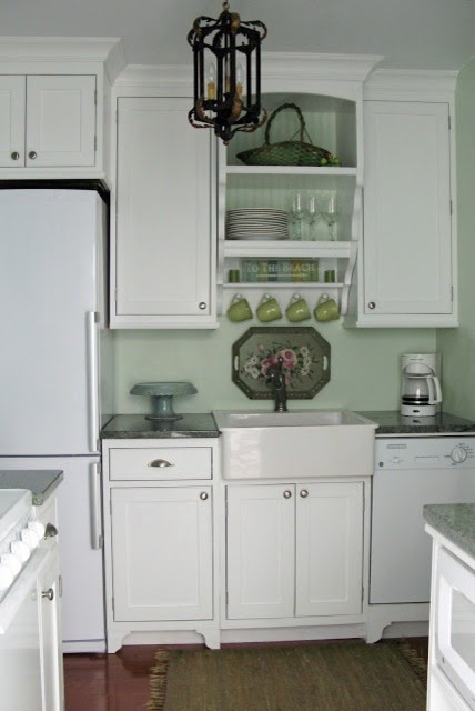 This is an example of a traditional kitchen in Chicago with open cabinets and white appliances.