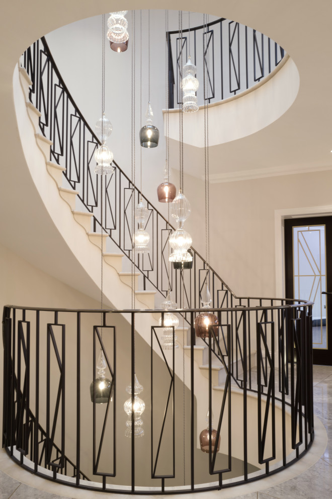 Large minimalist limestone curved metal railing staircase photo in Other with limestone risers