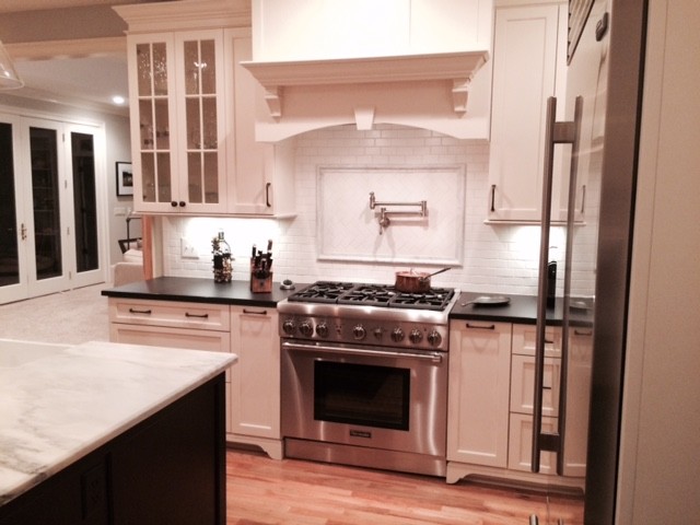 Inspiration for a transitional kitchen remodel with shaker cabinets, white cabinets and an island