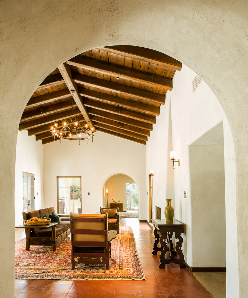 Huge southwest formal and enclosed concrete floor and red floor living room photo in Phoenix with white walls, a standard fireplace, a plaster fireplace and no tv