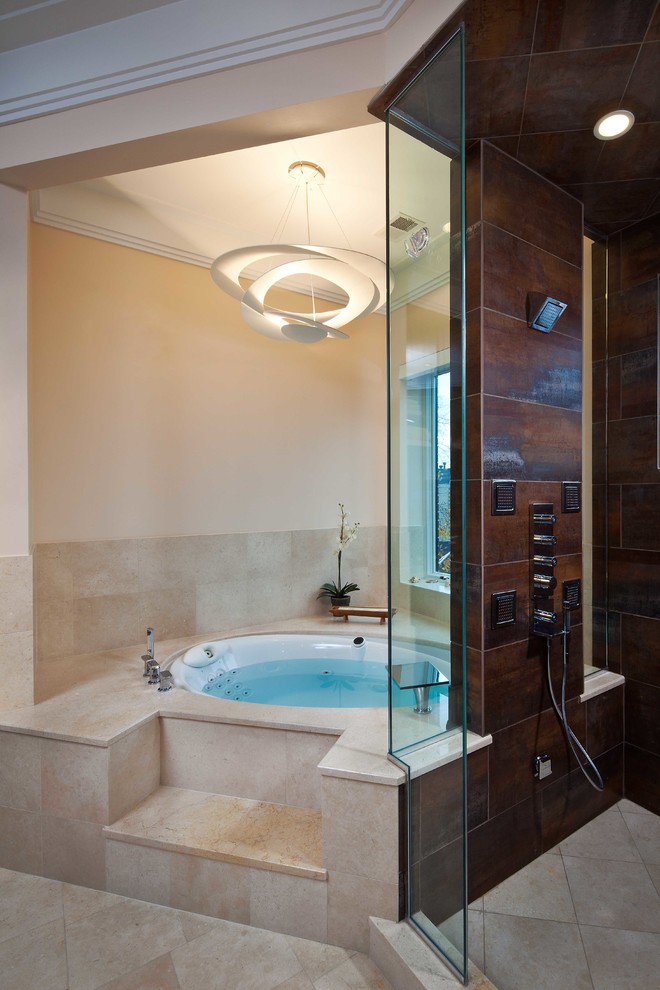 Photo of a contemporary bathroom in Other with a corner shower and beige tile.