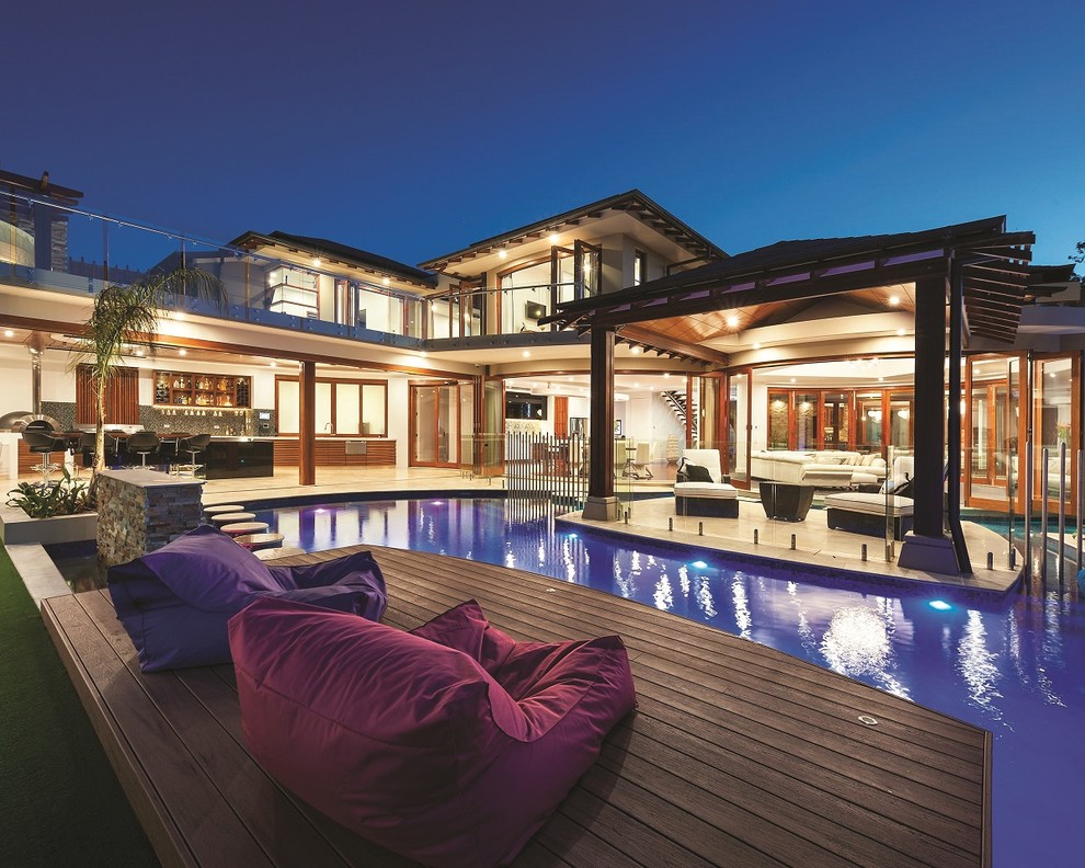 Photo of a contemporary backyard custom-shaped pool in Melbourne with decking.