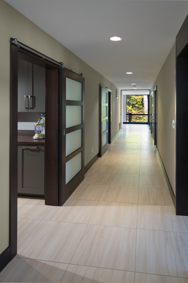 Mid-sized contemporary hallway in Cleveland with green walls, ceramic floors and beige floor.