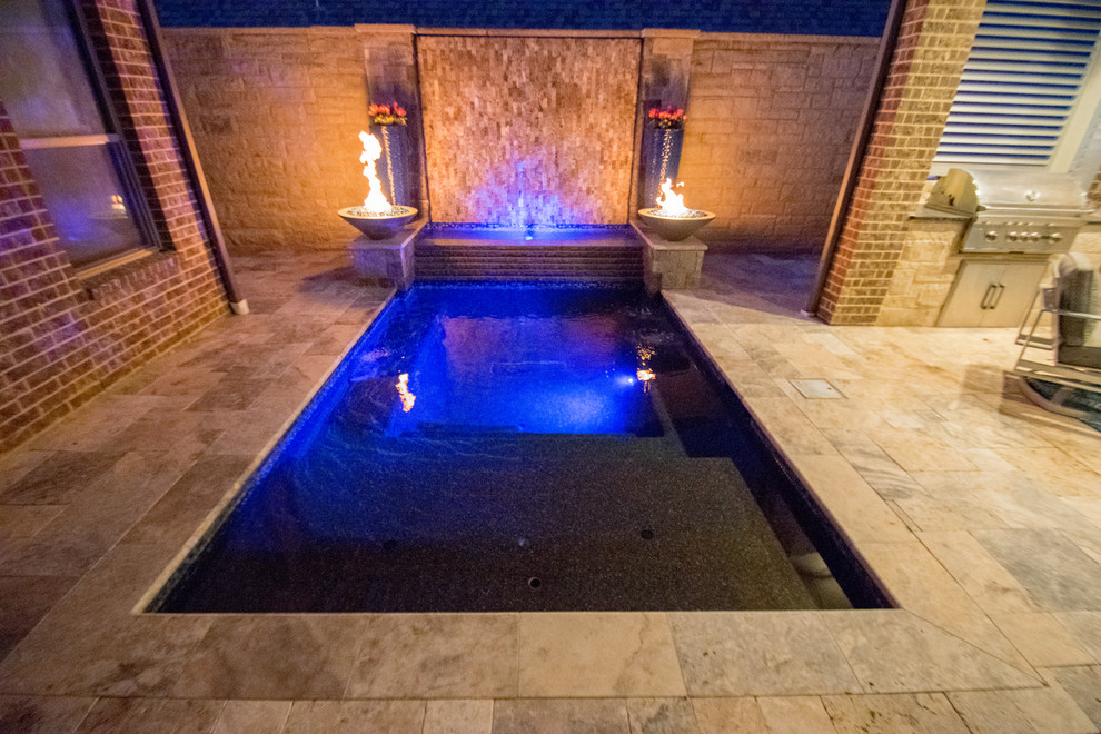 Inspiration for a small modern courtyard pool in Dallas with natural stone pavers.