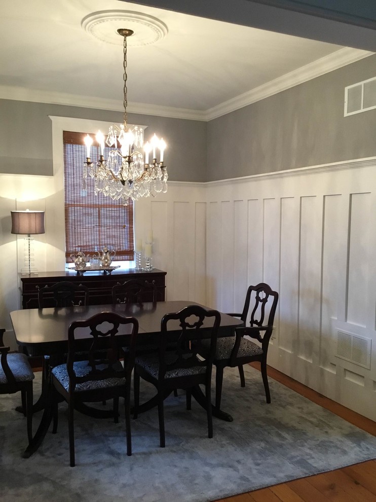 Photo of a mid-sized traditional separate dining room in Toronto with grey walls, medium hardwood floors and no fireplace.