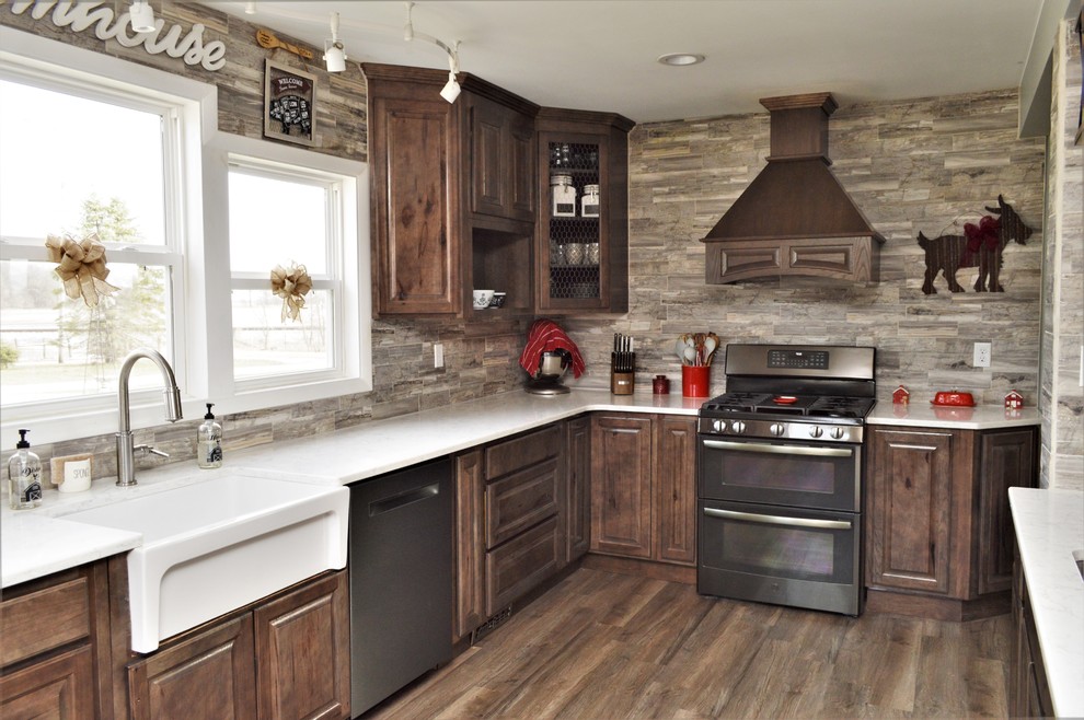 Design ideas for a large country u-shaped open plan kitchen in Chicago with a farmhouse sink, raised-panel cabinets, brown cabinets, quartzite benchtops, brown splashback, stainless steel appliances, with island, brown floor and white benchtop.