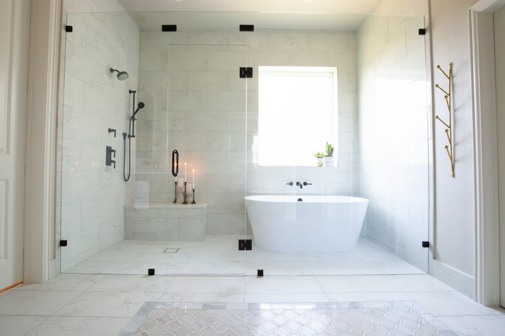 This is an example of a large transitional master wet room bathroom in Dallas with shaker cabinets, grey cabinets, a freestanding tub, a two-piece toilet, white tile, porcelain tile, grey walls, marble floors, an undermount sink, engineered quartz benchtops, beige floor, a hinged shower door, white benchtops, a shower seat, a double vanity and a built-in vanity.