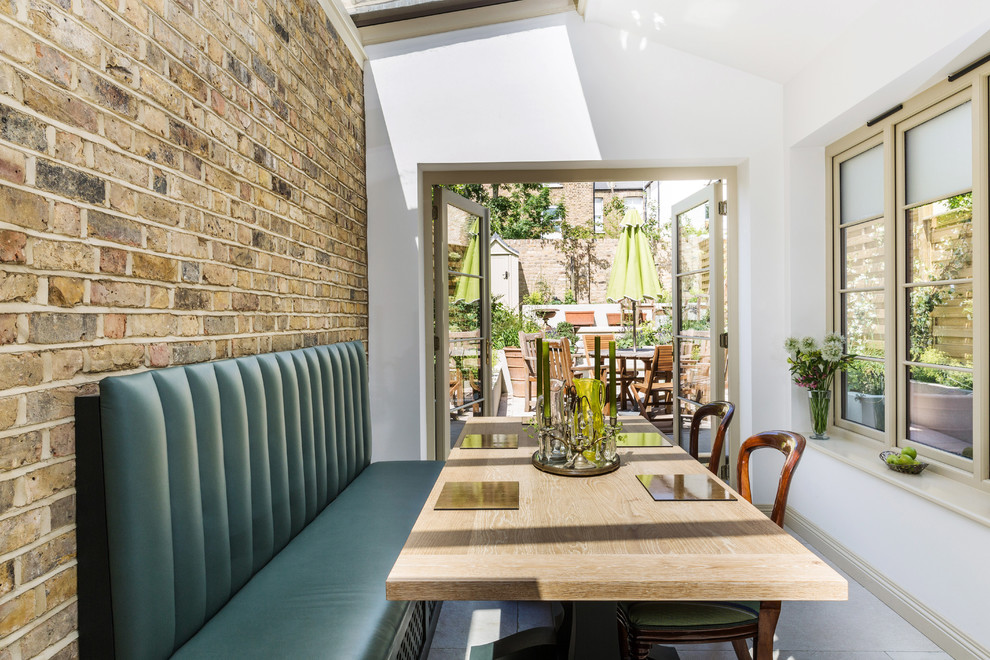 Inspiration for a large traditional kitchen/dining combo in London with limestone floors and white floor.