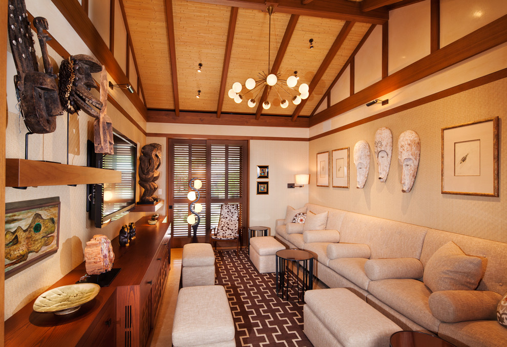 Photo of a tropical enclosed family room in Other with beige walls, no fireplace and a wall-mounted tv.