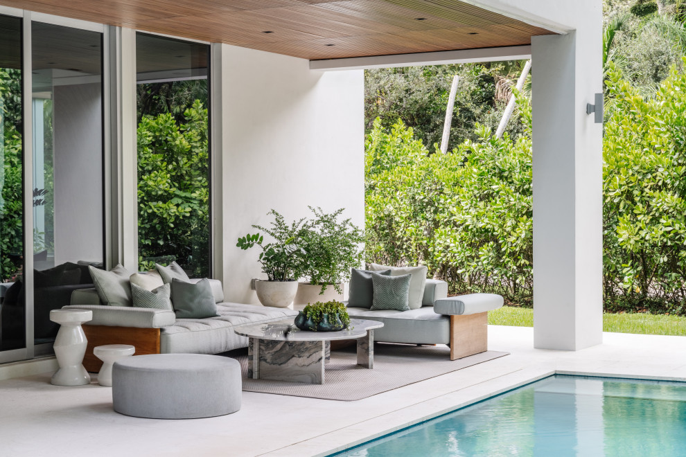Patio - contemporary patio idea in Miami with a roof extension