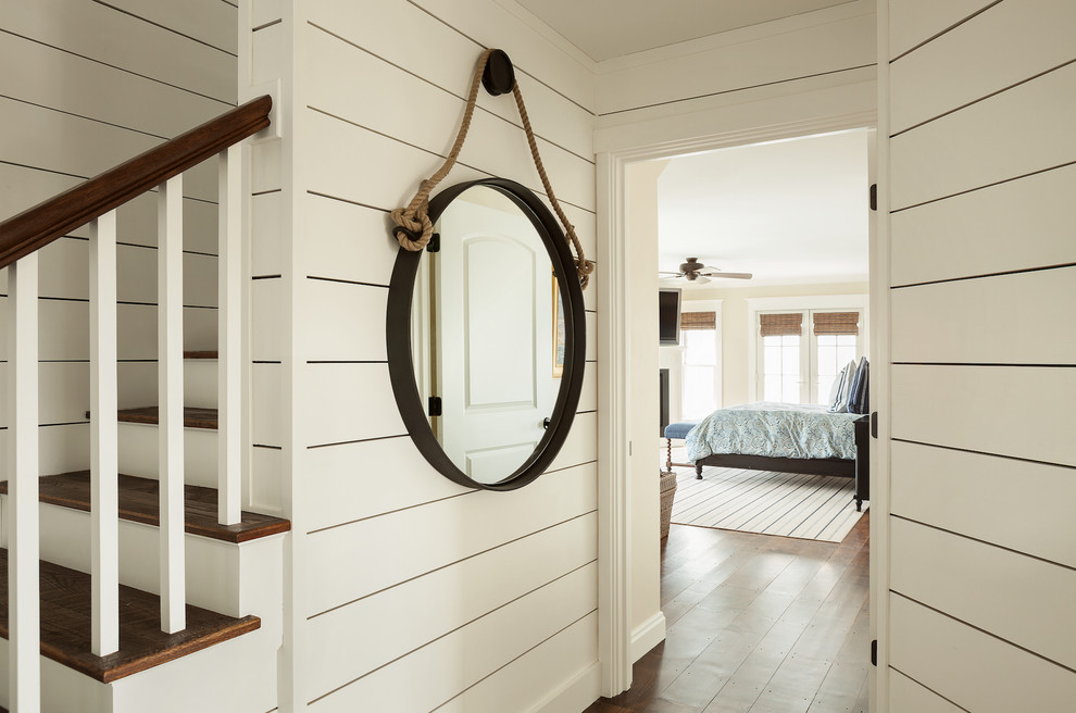 Inspiration for an expansive beach style hallway in Portland Maine with white walls and medium hardwood floors.