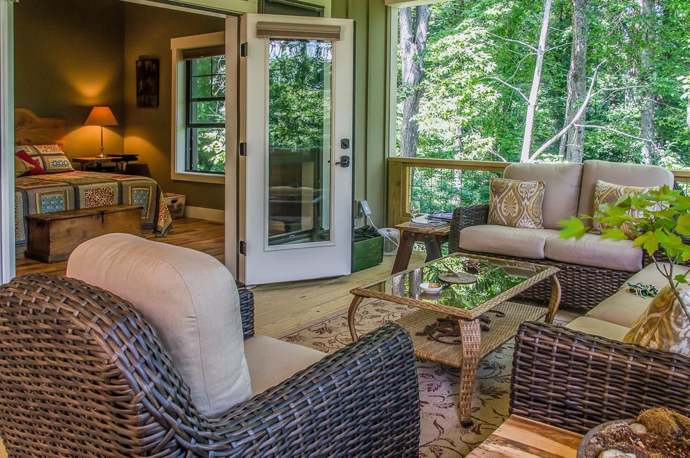 Inspiration for a mid-sized transitional screened-in back porch remodel with decking and a roof extension