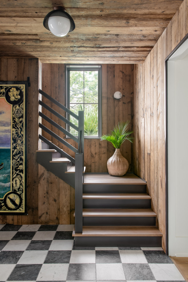 Sullivan's Island Remodel - Hallway and staircase featuring antique honed marble flooring in a checkerboard pattern, vertical mushroom board walls with matching wood ceiling.
