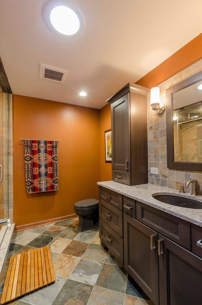 Photo of a mid-sized asian master bathroom in Chicago with an undermount sink, recessed-panel cabinets, grey cabinets, engineered quartz benchtops, an alcove shower, a two-piece toilet, multi-coloured tile, porcelain tile, orange walls and porcelain floors.