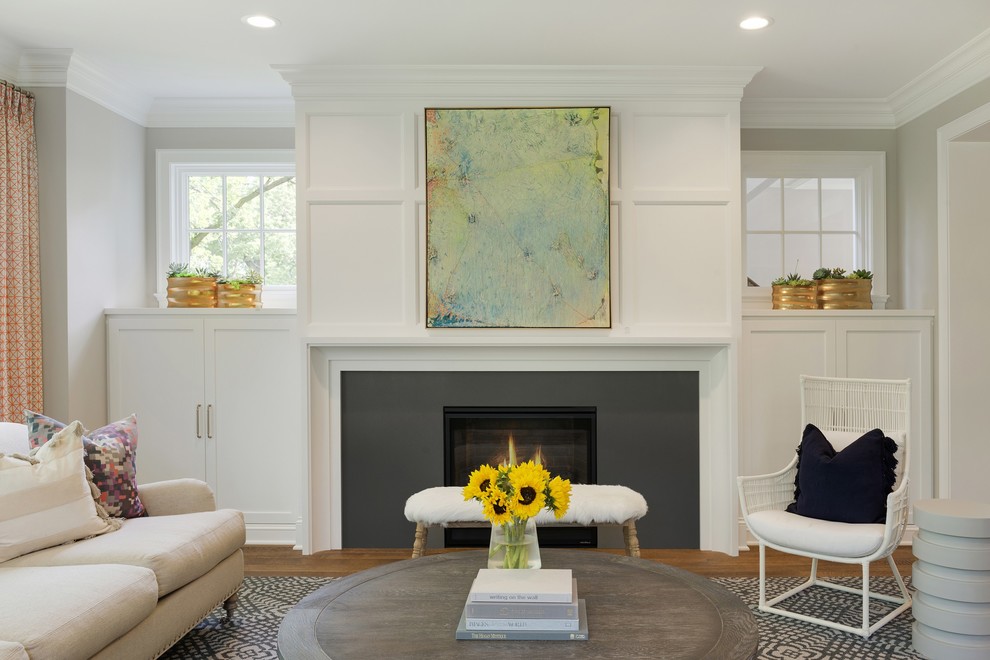 Large beach style formal open concept living room in Minneapolis with white walls, medium hardwood floors, a standard fireplace, a concrete fireplace surround and brown floor.