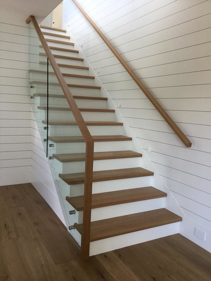 Inspiration for a mid-sized contemporary wood straight staircase in Vancouver with painted wood risers and mixed railing.
