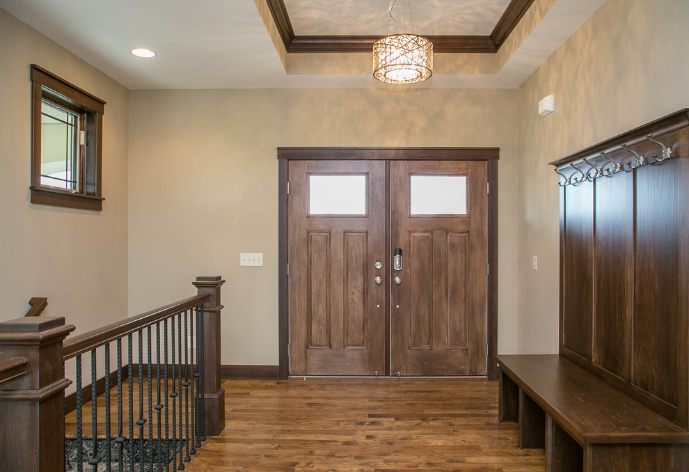 Example of a transitional dark wood floor foyer design in Minneapolis with beige walls and a dark wood front door
