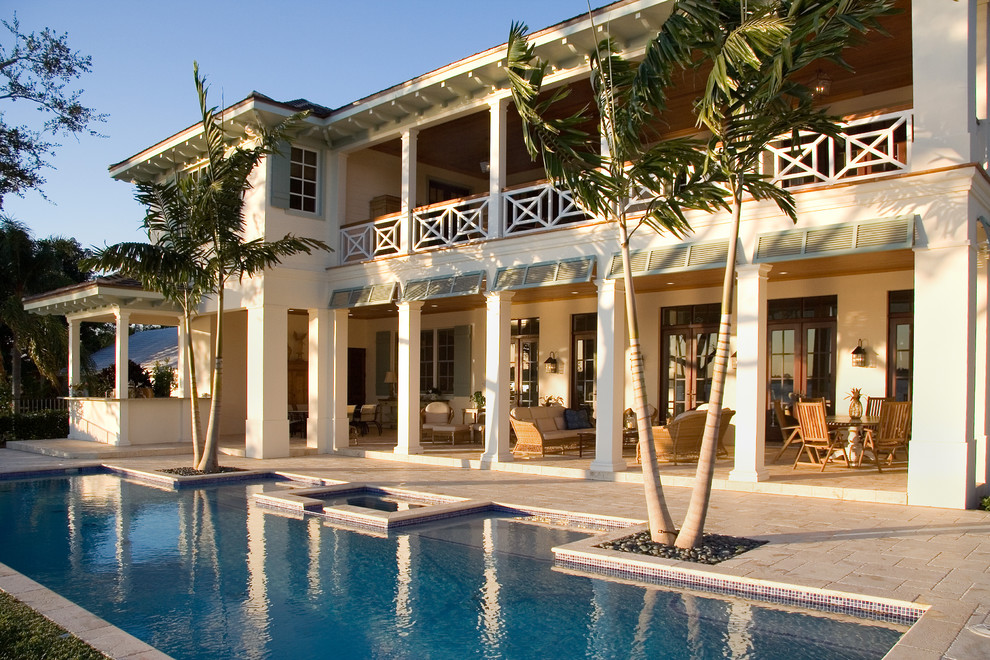 Photo of a tropical backyard custom-shaped pool in Miami.